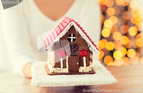 Image of close up of woman showing gingerbread house