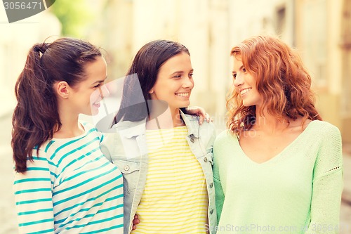 Image of smiling teenage girls with on street