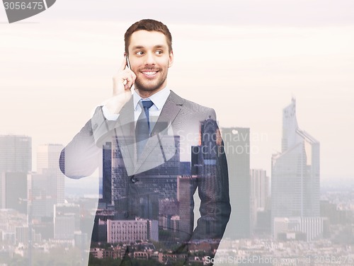 Image of smiling young businessman over city background