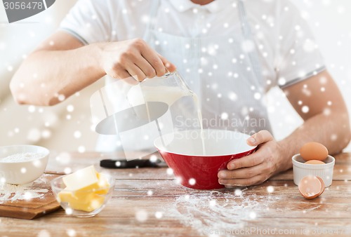 Image of close up of man pouring milk into bowl