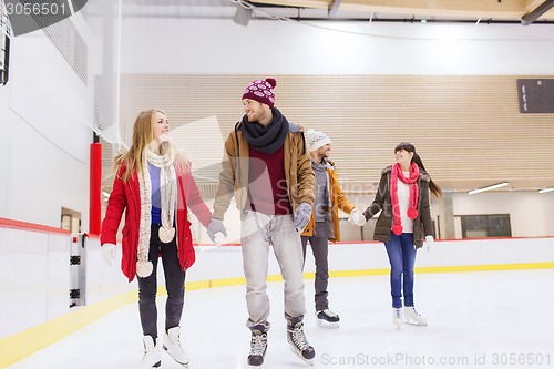 Image of happy friends on skating rink