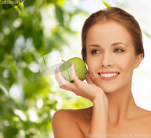 Image of smiling young woman with green apple