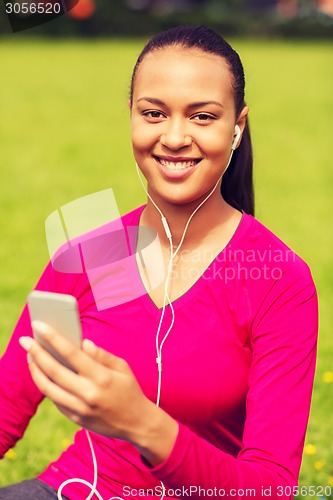 Image of smiling african american woman with smartphone