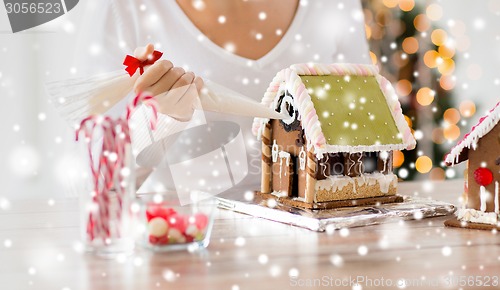 Image of close up of woman making gingerbread houses