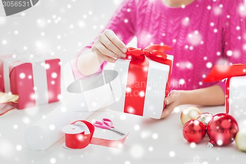 Image of close up of woman decorating christmas presents
