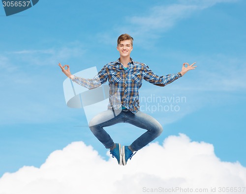 Image of smiling young man flying in air