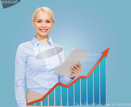 Image of young smiling businesswoman with tablet pc
