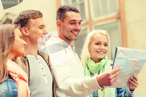 Image of group of friends with map exploring city