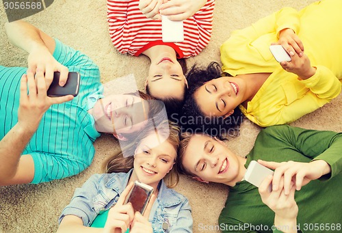 Image of group of smiling people lying down on floor