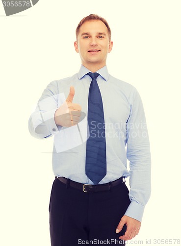 Image of smiling businessman showing thumbs up