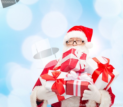 Image of man in costume of santa claus with gift boxes