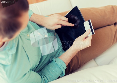 Image of close up of man with laptop and credit card