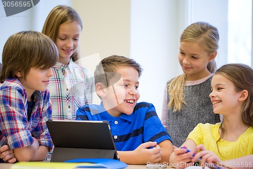 Image of group of school kids with tablet pc in classroom