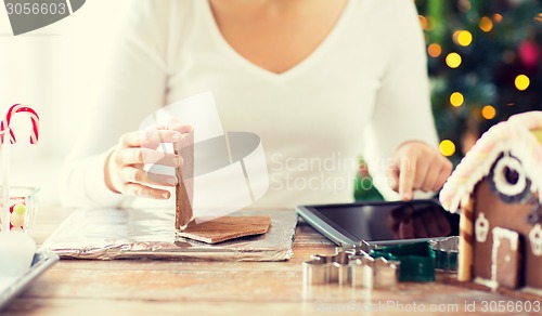 Image of close up of woman making gingerbread houses