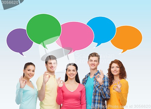 Image of group of smiling teenagers showing ok sign