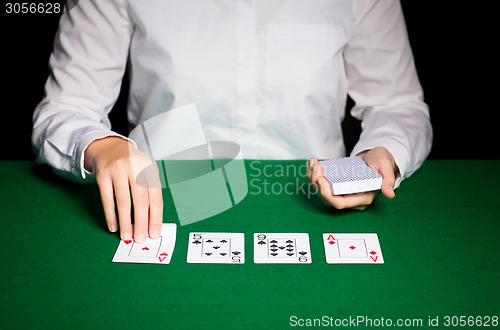 Image of holdem dealer with playing cards