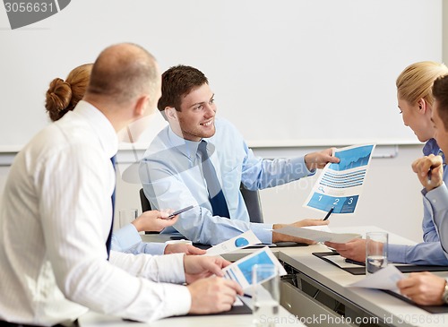 Image of business people with papers meeting in office