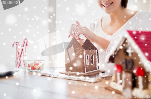 Image of close up of woman making gingerbread houses