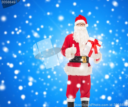 Image of man in costume of santa claus with gift box