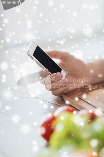 Image of closeup of man reading recipe from smartphone