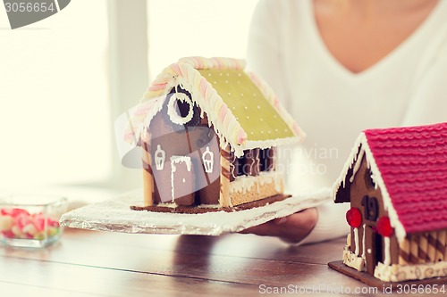 Image of close up of woman showing gingerbread house