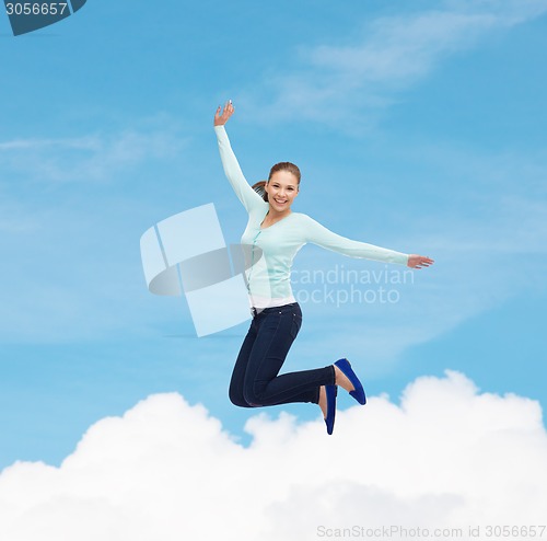 Image of smiling young woman jumping in air