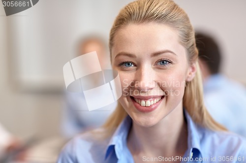Image of group of smiling businesspeople meeting in office