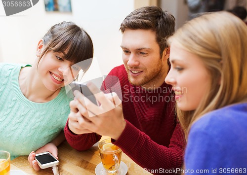 Image of group of friends with smartphones meeting at cafe