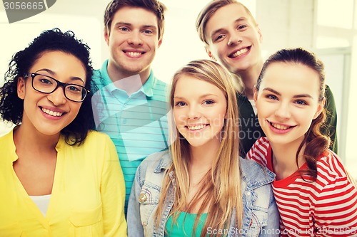 Image of group of smiling people at school or home