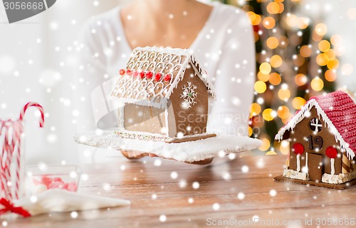 Image of close up of woman showing gingerbread house