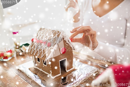 Image of close up of woman making gingerbread houses