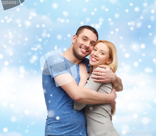 Image of happy couple hugging outdoors