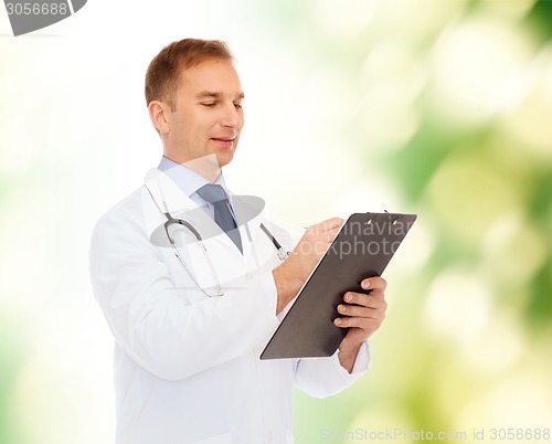 Image of smiling male doctor with clipboard and stethoscope