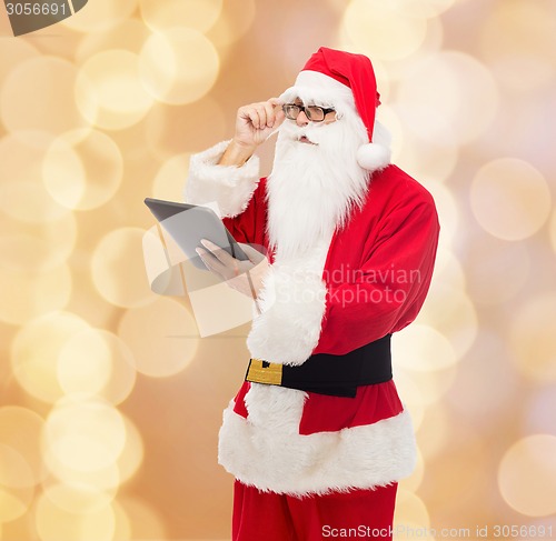 Image of man in costume of santa claus with tablet pc