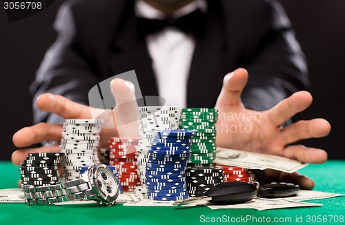 Image of poker player with chips and money at casino table