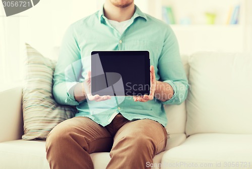 Image of close up of man with tablet pc computer at home