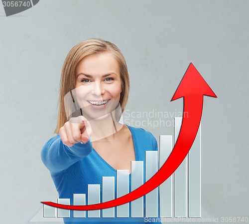 Image of smiling young businesswoman pointing at you