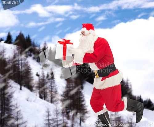 Image of man in costume of santa claus with gift box