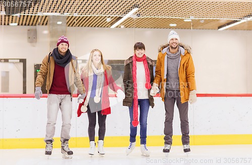 Image of happy friends on skating rink