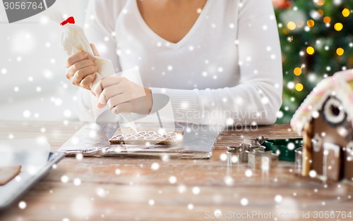 Image of close up of woman making gingerbread houses