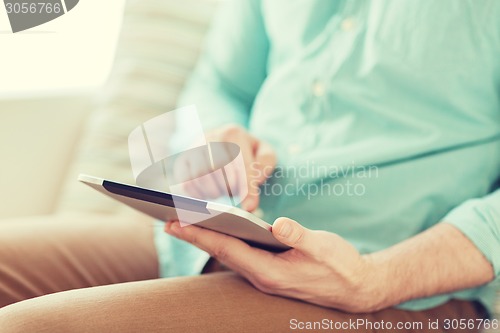 Image of close up of man with tablet pc computer at home