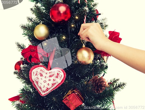 Image of close up of woman with christmas tree decoration