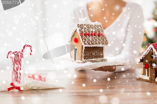 Image of close up of woman showing gingerbread house