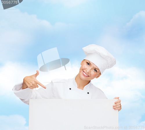 Image of smiling female chef with white blank board