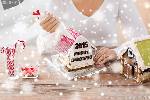 Image of close up of woman making gingerbread houses