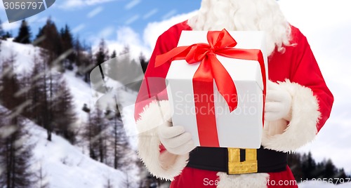 Image of man in costume of santa claus with gift box