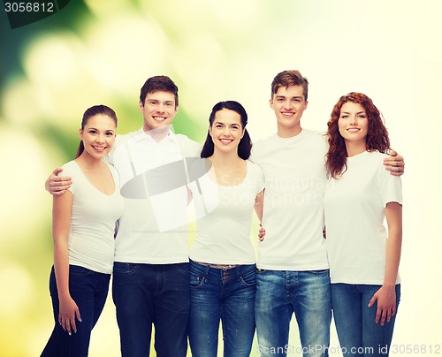 Image of group of smiling teenagers in white blank t-shirts