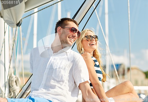 Image of smiling couple sitting on yacht deck