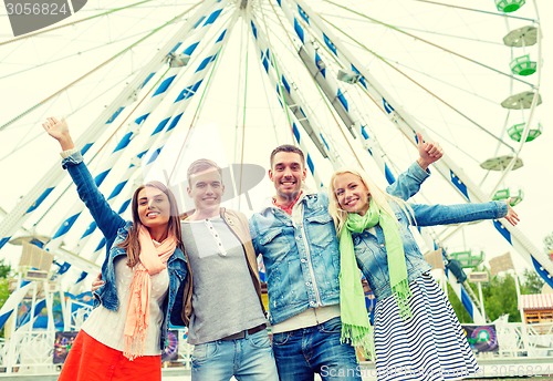 Image of group of smiling friends waving hands