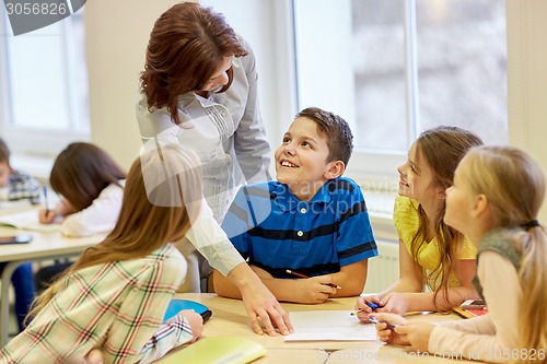 Image of group of school kids writing test in classroom